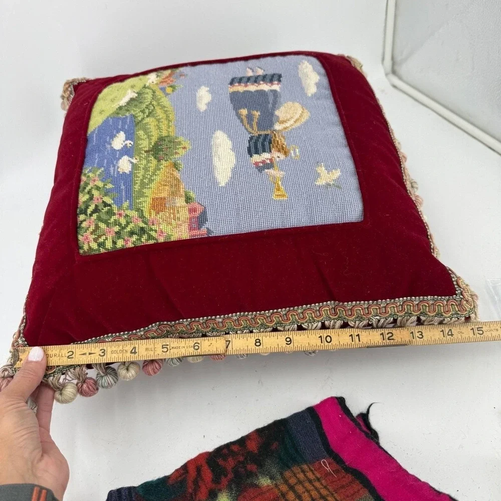 Needlepoint pillow featuring a folk art angel motif dark red velvet background